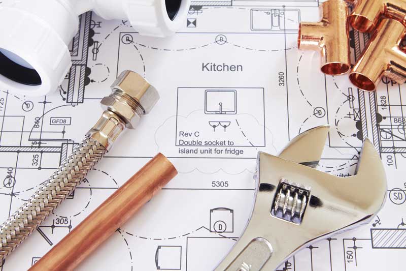 plumbing tools on a set of plans